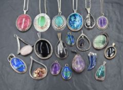 A large selection of Artisan style polished stone and shell pendants, all set in white metal,