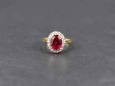 An oval synthetic ruby and diamond chip cluster ring having a claw set raised mount on an 18ct