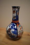 A 20th century Japanese Imari onion form vase decorated with panels of landscapes and perched
