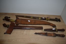 A 19th/20th Century Eastern Moro Barong sword, within a copper wire bound scabbard and having a