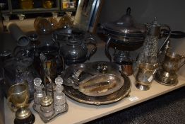An assortment of silver-plated ware including teapots, tankards, condiment set and a chafing dish