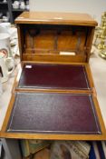 An attractive late 19th/early 20th century oak stationary box which develops into a writing slope.