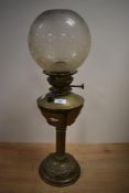 A Victorian brass column oil lamp, of traditional design with shell moulding to the base, reeded