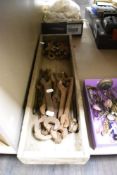 A selection of vintage tools including spanners within a rectangular rustic tray