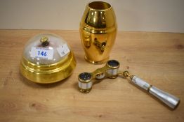 A pair of gilt metal and abalone shell opera glasses with pivoting handle, unmarked, and sold