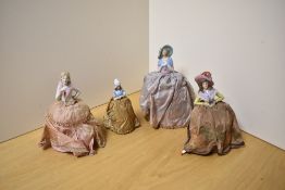 Four early 20th Century pin cushion half dolls, the largest measures 24cm high
