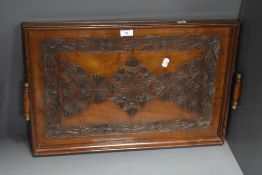 A 19th Century mahogany rectangular tray with carved design and moulded handles, measuring 50cm