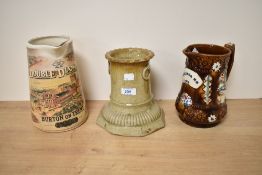 A 19th/20th Century treacle glazed barge ware pitcher, with applied decoration and 'Remember Me'