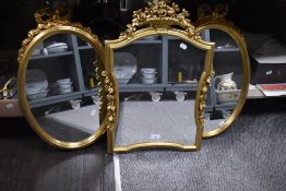 Three modern gilt framed mirrors, two matching oval shape 52cm x 38cm and an ornate floral