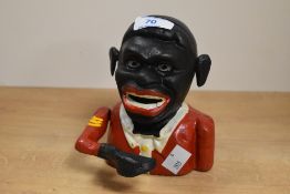 A 20th Century cast iron mechanical money bank in the form of a Jolly man, measuring 14cm high