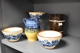Three Wetheriggs pottery bowls, decorated with an unusual blue flower design against a cream ground,