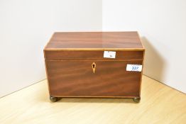 An attractive Regency mahogany tea caddy, of oblong form with boxwood stringing and lozenge
