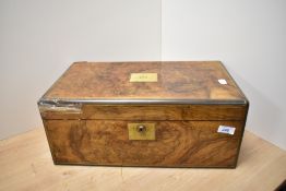 A Victorian walnut writing slope, the case with central initialled, brass cartouche and stringing,