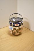 A Royal Crown Derby biscuit jar, having a silver coloured lid and handle, in the Imari pattern and