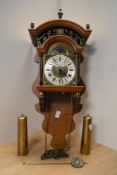 A 20th Century German reproduction pendulum wall clock, in the style of the clocks produced by