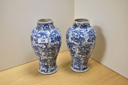 A pair of 19th Century Chinese blue and white vases, of baluster form with hand painted decoration