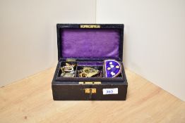 A small black jewellery box, containing tiepins, badges and cufflinks
