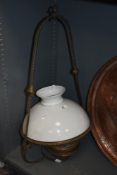 A late 19th Century copper hanging lamp, having a milk glass shade and suspended within a rope twist