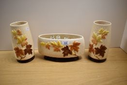 Three 1960s Sylvac Autumn Leaves patterned vases, to include a pair of cylindrical tapering vases