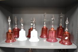 Nine Victorian cranberry and other glass bells, the tallest measures 33cm high