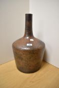 A large, mid-20th Century stoneware bottle vase, glazed in a mottled brown, measuring 45cm high