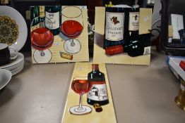 Three modern porcelain display tile plaques having wine bottle and glass decoration.