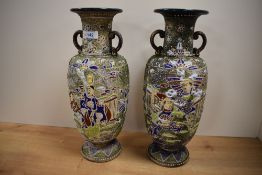 A pair of 20th Century Japanese 'enamelled' Satsuma vases of urn form, decorated with bands of