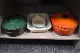A small quatity of French enamelled metal and stone ware cook wares, Le Crueset orange enamelled