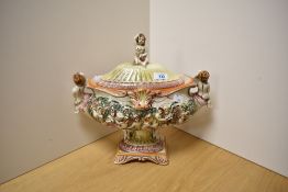 A 1940s Capodimonte porcelain lidded tureen, hand painted and decorated in relief with putti,