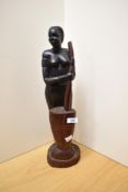 A 20th Century African carved hardwood sculpture of an indigenous woman, measuring 50cm high