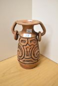 A 20th Century clay pottery vase, of Aztec style with two ringed handles and signed 'Para Pedro