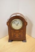An Edwardian mahogany mantel clock by W.Potts & Sons of Leeds, the domed, satinwood inlaid case