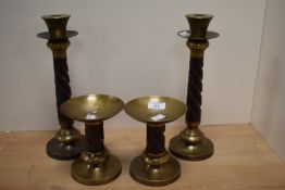 A pair of mid-20th Century turned wooden candlesticks, measuring 31cm high, and a pair of matching