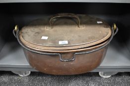 A 19th Century lidded copper fish kettle or cooking vessel, having cast iron carrying handle and