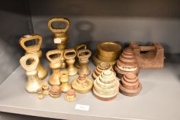 A selection of 19th Century brass bell and graduating weights, the largest bell weight (7lbs)