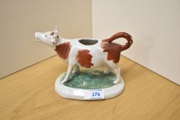 A 19th Century Staffordshire porcelain cow creamer, measuring 18cm long