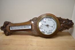 A late 19th Century oak cased aneroid barometer, measuring 35cm long