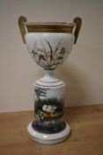 A late 19th Century aesthetic period opaque glass jardiniere and stand, the design depicting birds