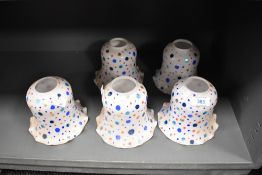 A selection of early 20th Century milk glass light shades with polka dot decoration, each