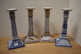 Two pairs of attractive Portuguese ceramic candlesticks, hand painted in polychrome and blue and