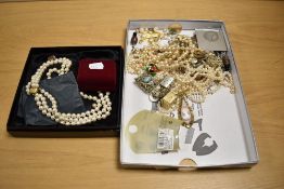 An assorted collection of costume jewellery, including strings of faux pearls, pendants, and