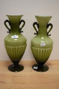 A pair of 20th Century Italian green cased glass vases, of urn form with half fluted bodies on