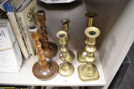 Two pairs of brass candlesticks together with a pair of turned oak candlesticks.