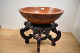 An earthern ware/terracotta bowl, of circular form with reeded detail to the exterior, 36cm some