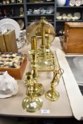 A selection of 19th/20th Century brassware, to include a footman, candlesticks, and candle snuffer