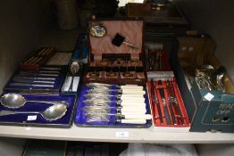 A selection of silver-plated flatware comprising of desert knives and forks, serving spoons and