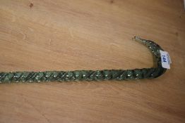 A Victorian green glass Nailsea type walking stick, of slender twisted form with short curved handle