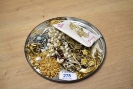 An assortment of costume brooches and pins, including large statement pieces, enamelled floral