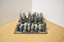 An interesting 20th Century East African design chess set, comprising thirty one soapstone carved