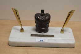 A mid-20th Century commemorative pen stand, the resin moulded crown and gilt metal pen holders
